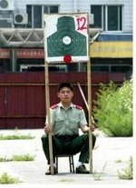 chinese-soldier-holding-target-with-white-sides-218x300.jpg