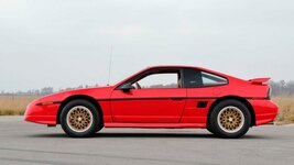 1988-Pontiac-Fiero-GT-exterior-002-Mecum-Auctions-Bright-Red-driver-proflie-720x405.jpg