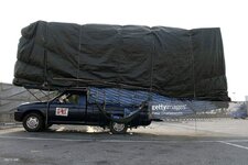the-driver-of-an-overloaded-pickup-truck-takes-a-nap-in-a-hammock-picture-id166751439.jpg