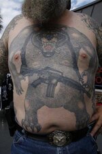 giant-bear-carrying-gun-tattoo-on-upperbody.jpg