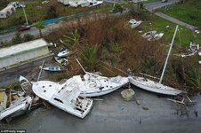 00578-4908648-Damaged_sail_boats_washed_ashore_are_seen_in_the_aftermath_of_Hu-a-6_1506066373496.jpg