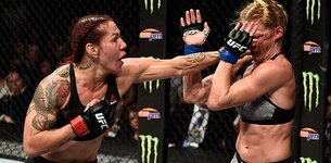Cris-Cyborg-punches-Holly-Holm-to-cage-UFC-219-UFC-photo.jpg