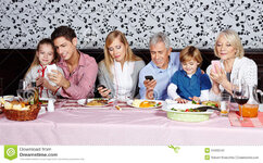 ly-looking-their-smartphones-dinner-table-34350242.jpg
