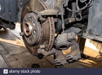 disassembled-front-brake-caliper-on-the-car-which-is-on-the-car-jack-in-the-workshop-2D7MRT0.jpg